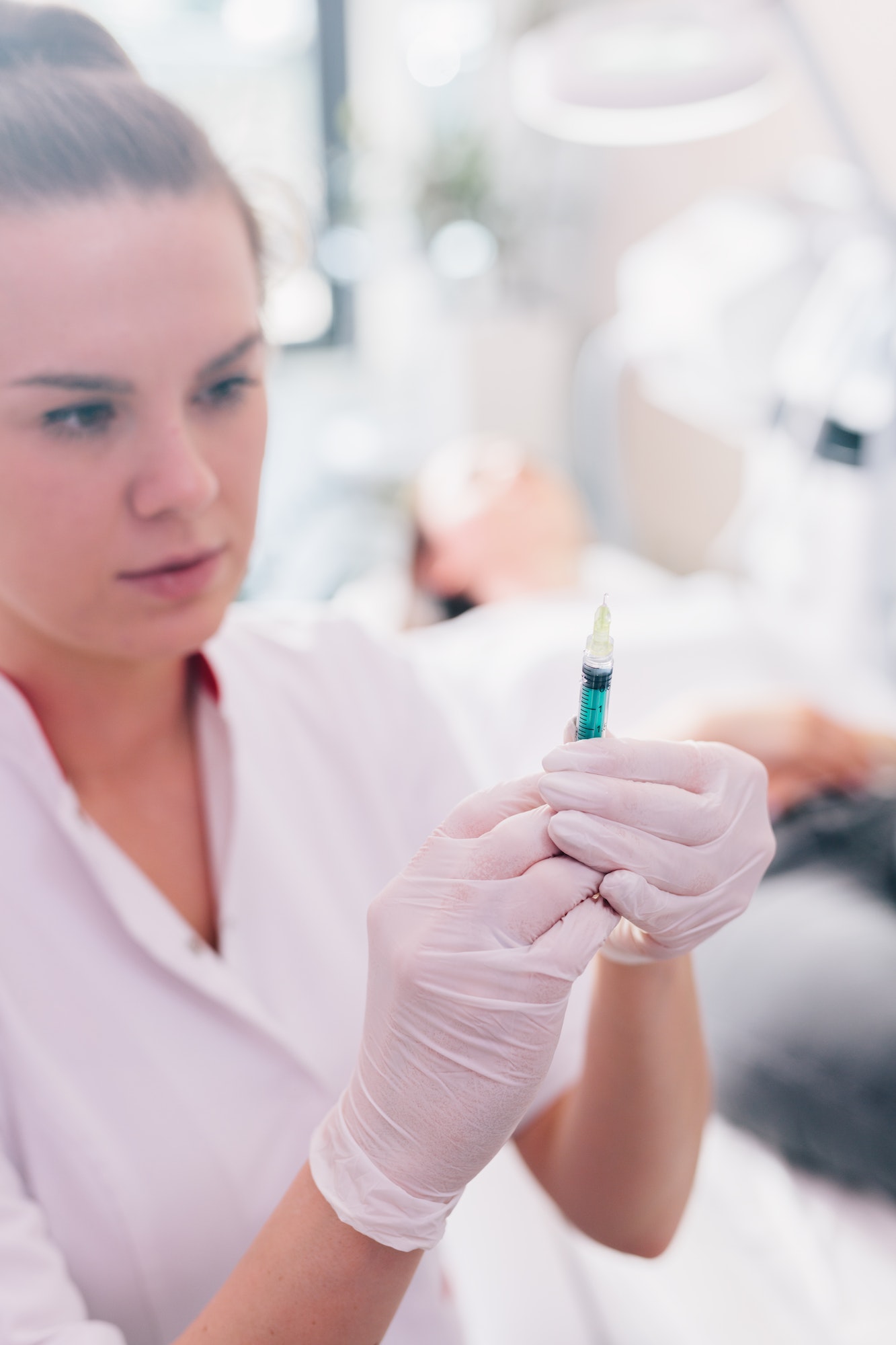 Aesthetic medicine doctor preparing syringe for injection